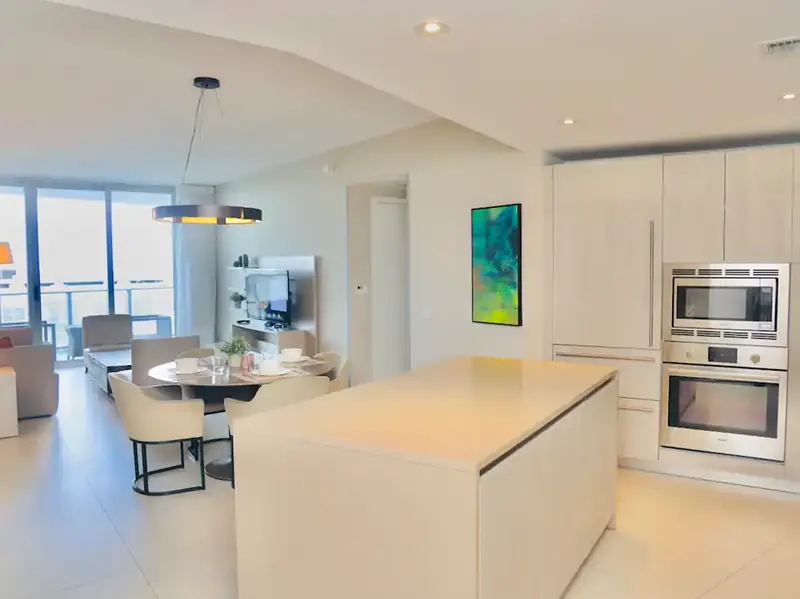 Open kitchen with island and ocean-view living area at Hyde Resort
