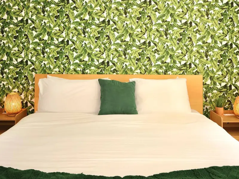 Bedroom with palm-leaf wallpaper